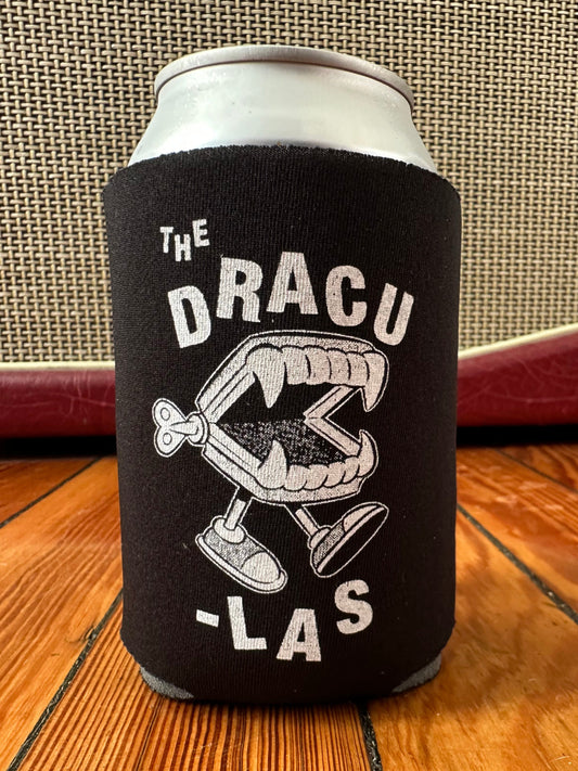 Black can cooler with The Dracu-Las' Wind-Up Fangs design on a wooden surface