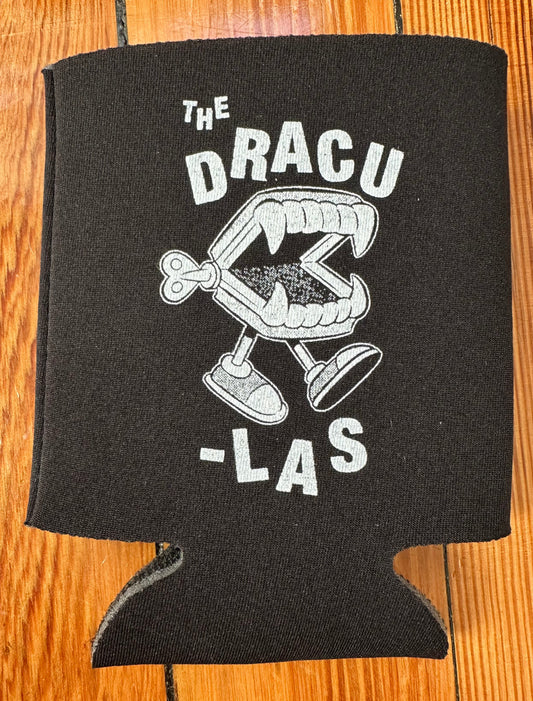 Black can cooler with white The Dracu-Las Wind-Up Fangs text and graphic on a wooden surface